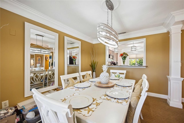 carpeted dining space with a notable chandelier, ornate columns, and crown molding