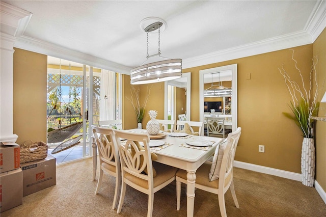 carpeted dining space with a notable chandelier and ornamental molding