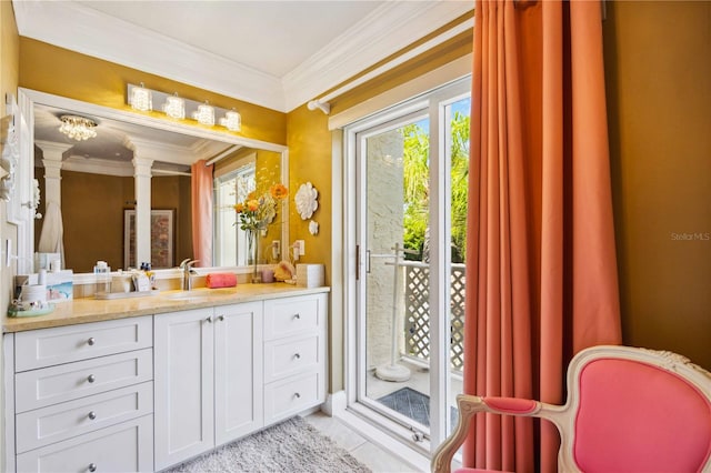 bathroom with a healthy amount of sunlight, ornamental molding, and decorative columns