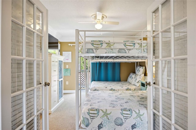 carpeted bedroom featuring ceiling fan, a textured ceiling, and french doors