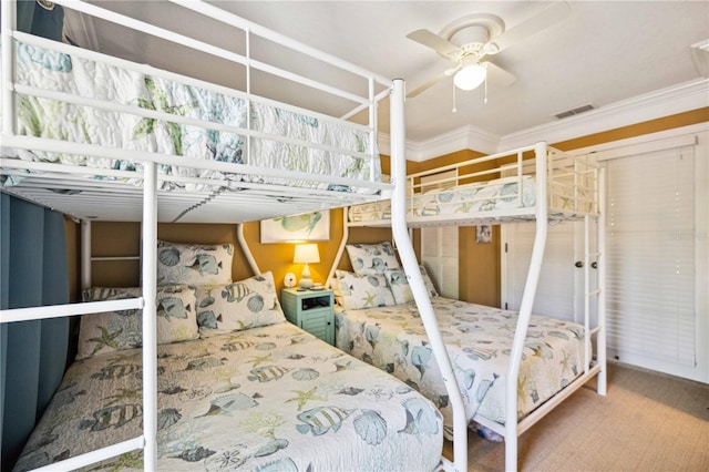 bedroom with carpet flooring, ceiling fan, and ornamental molding