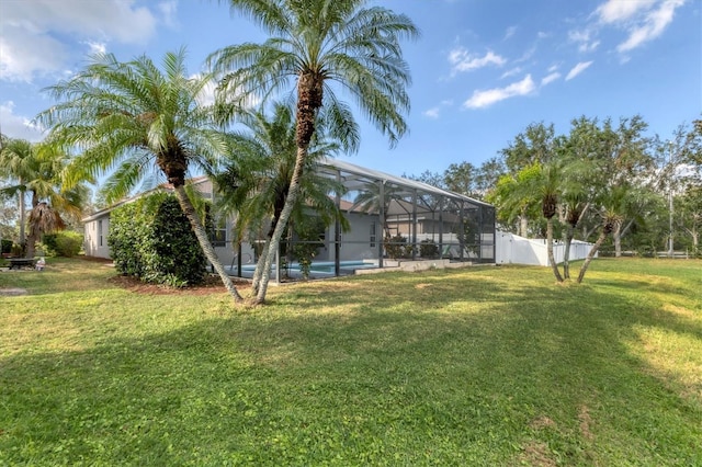 view of yard with glass enclosure