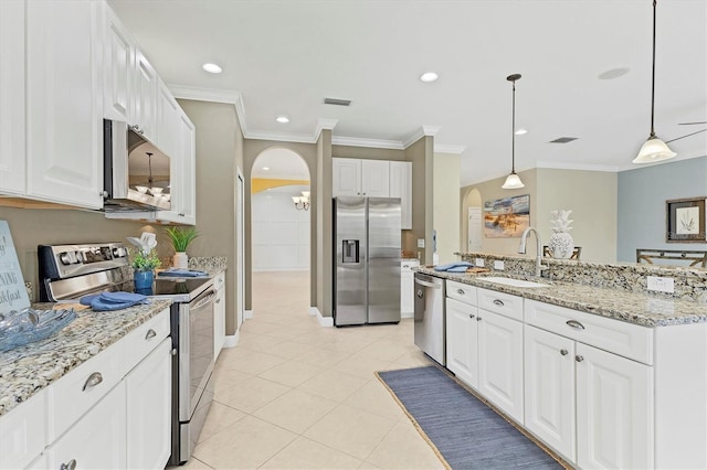 kitchen with sink, hanging light fixtures, light tile patterned floors, white cabinetry, and stainless steel appliances