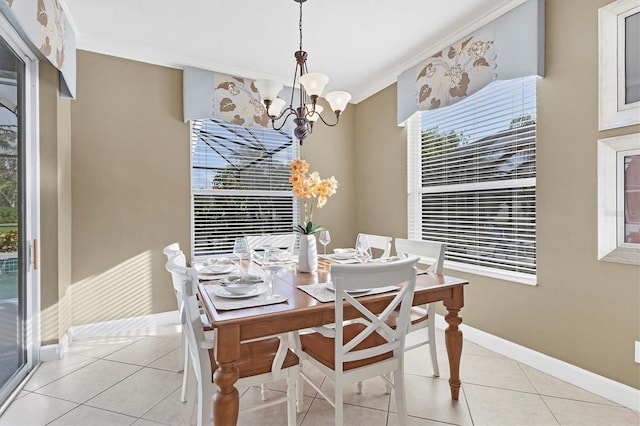 tiled dining space featuring crown molding and a chandelier