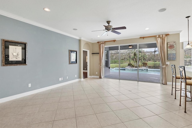 tiled spare room with ceiling fan and ornamental molding