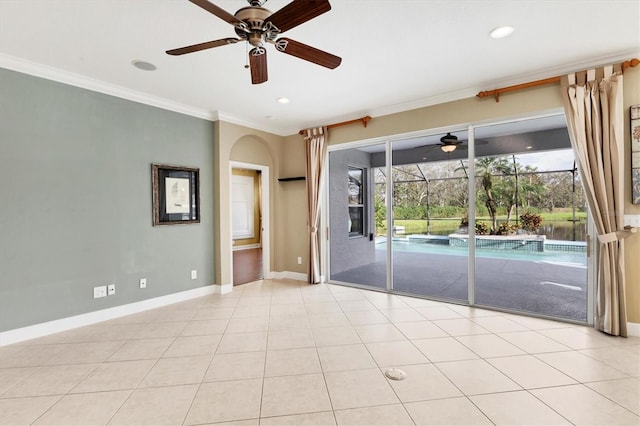 tiled spare room with ceiling fan and ornamental molding