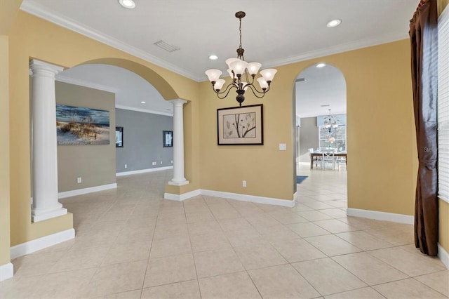 tiled empty room featuring decorative columns, crown molding, and a chandelier