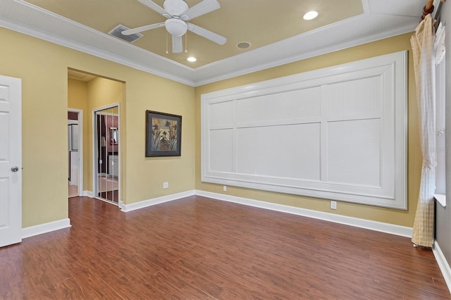 spare room with dark hardwood / wood-style floors, ceiling fan, and crown molding