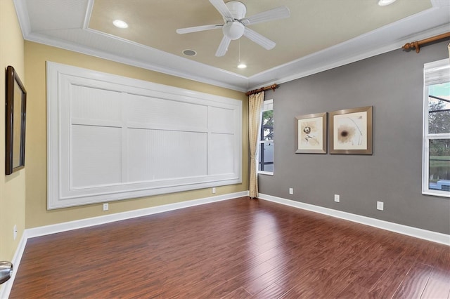 spare room featuring ceiling fan, crown molding, and dark wood-type flooring