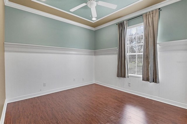 empty room featuring ceiling fan, dark hardwood / wood-style flooring, and ornamental molding