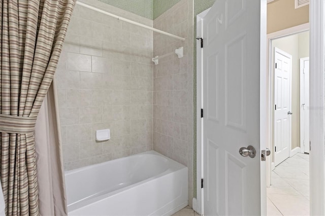 bathroom with tile patterned floors and shower / bath combo