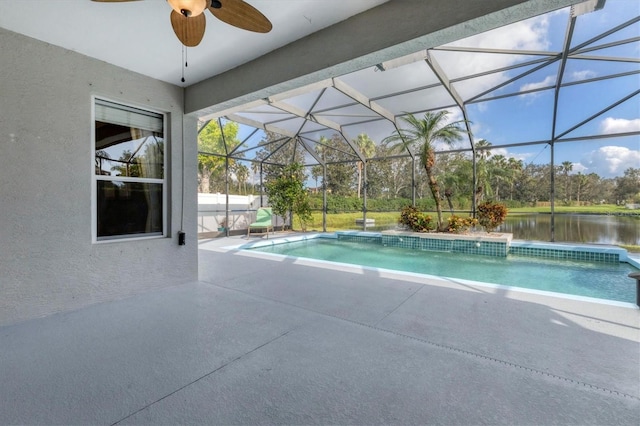 view of pool featuring a water view, glass enclosure, ceiling fan, and a patio area