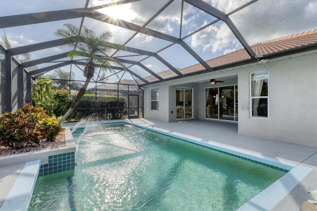 view of pool with ceiling fan, a lanai, and a patio