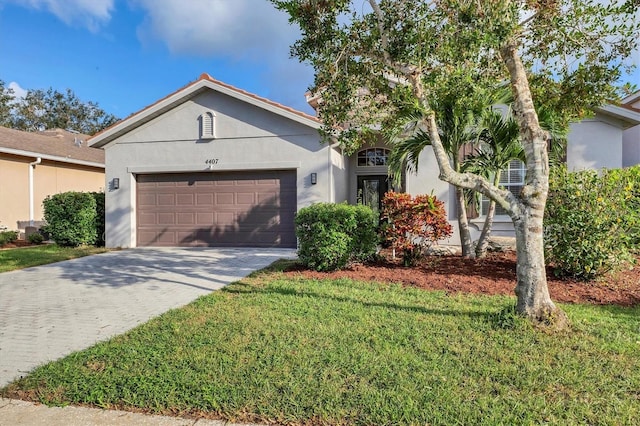 ranch-style home with a garage and a front lawn