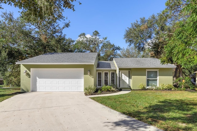 ranch-style home with a garage and a front lawn