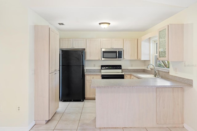 kitchen featuring sink, kitchen peninsula, light brown cabinetry, light tile patterned floors, and black appliances