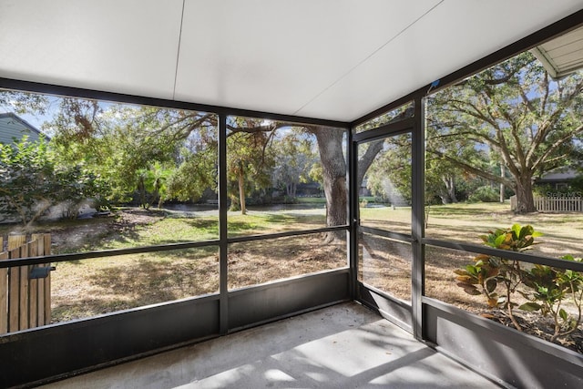 unfurnished sunroom with lofted ceiling