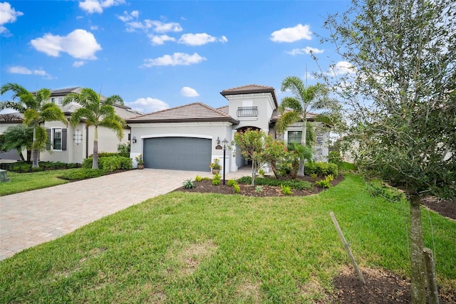 mediterranean / spanish home featuring a garage and a front yard