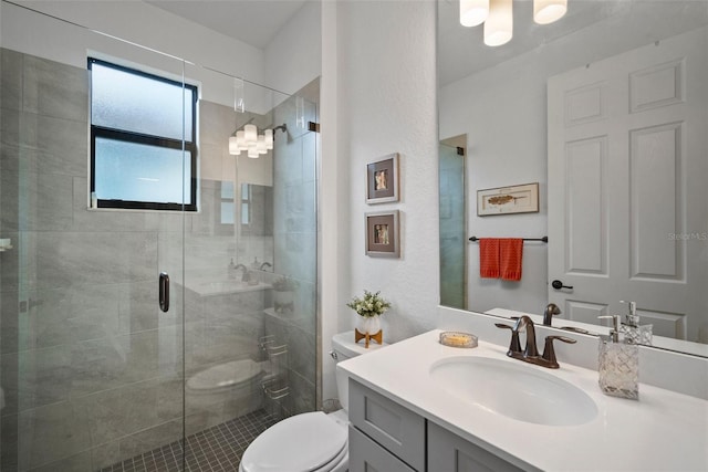 bathroom with tile patterned floors, vanity, toilet, and walk in shower