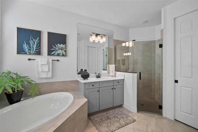 bathroom with tile patterned flooring, vanity, and independent shower and bath