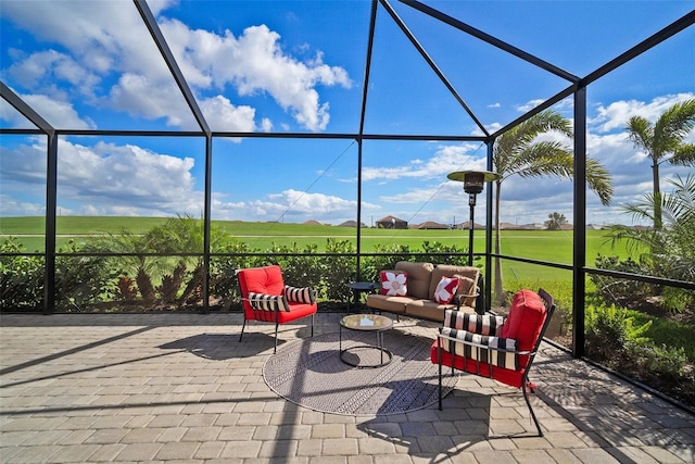 view of patio with outdoor lounge area and glass enclosure