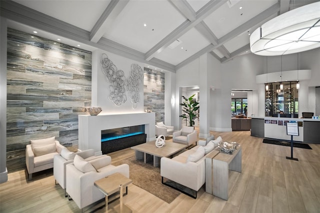 living room featuring light hardwood / wood-style flooring, beamed ceiling, and tile walls