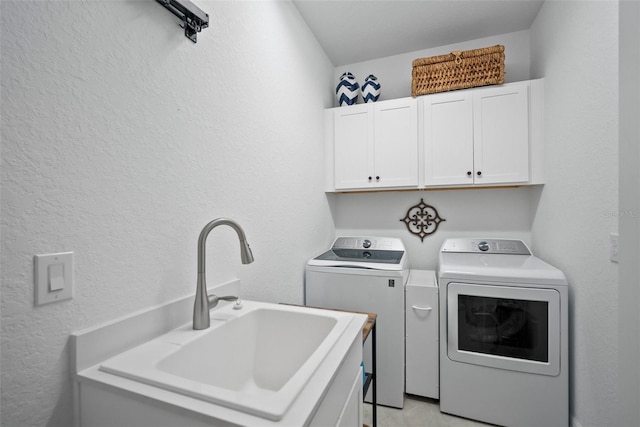 laundry room with cabinets, sink, and washer and dryer