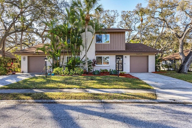 view of front of home featuring a front yard and a garage