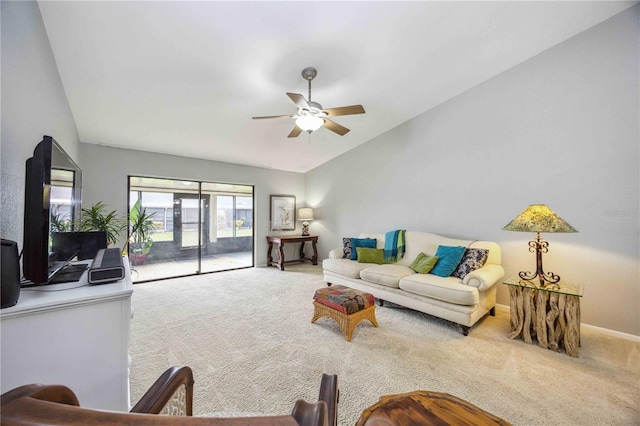 carpeted living room with ceiling fan and vaulted ceiling