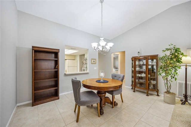 tiled dining area with a notable chandelier and lofted ceiling