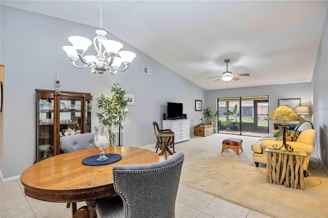 carpeted dining room with ceiling fan with notable chandelier and lofted ceiling