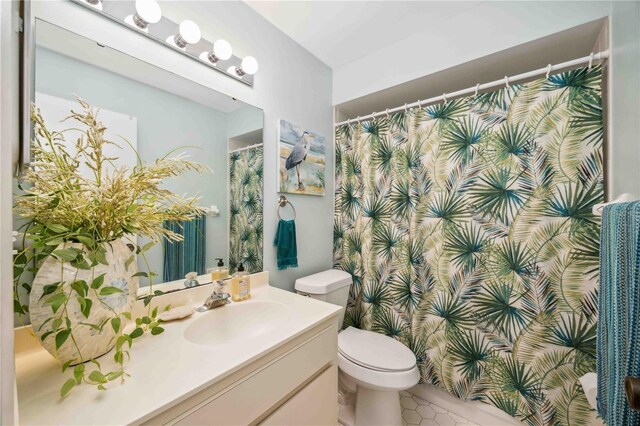 6515 Heritage Ln Unit 2615, Bradenton, FL 34209 - full bathroom featuring vanity, toilet, tile patterned flooring, and a shower with shower curtain