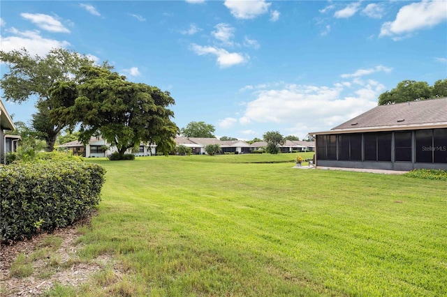 view of yard featuring a sunroom