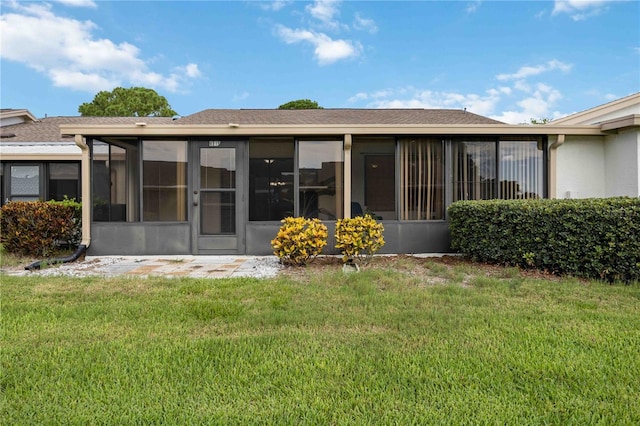 6515 Heritage Ln Unit 2615, Bradenton, FL 34209 - back of house featuring a sunroom, a lawn, and stucco siding