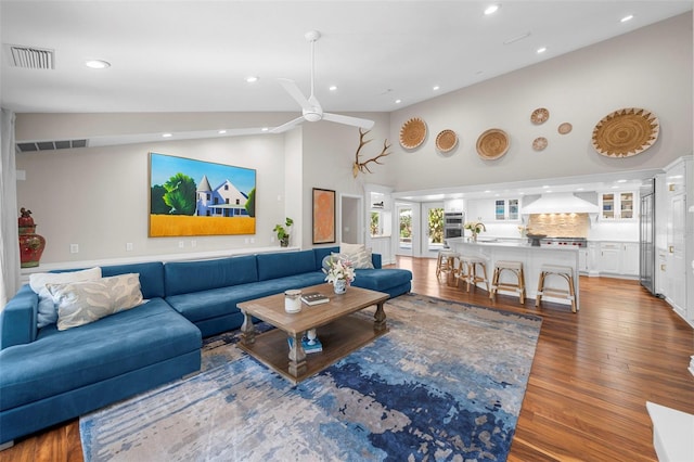 living room featuring ceiling fan, lofted ceiling, and hardwood / wood-style flooring