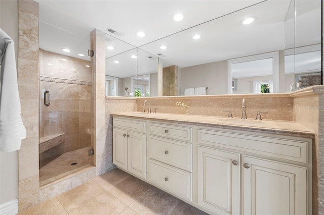 bathroom featuring tile patterned flooring, vanity, and walk in shower