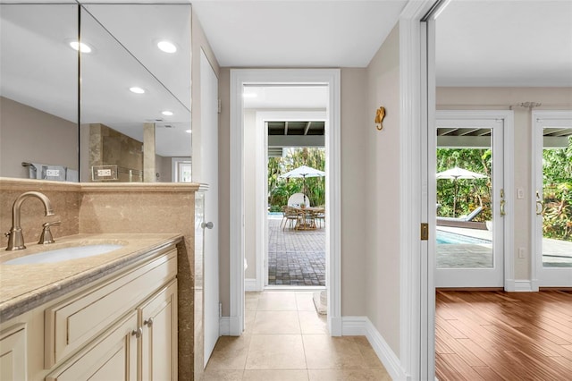 bathroom featuring vanity, hardwood / wood-style flooring, and a wealth of natural light