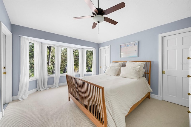 bedroom featuring light colored carpet and ceiling fan