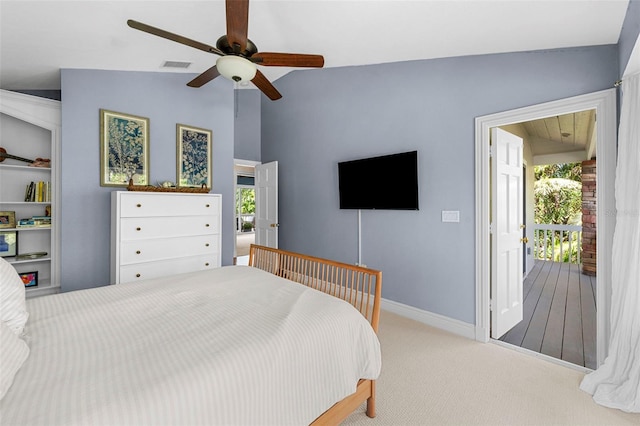 carpeted bedroom with ceiling fan and vaulted ceiling