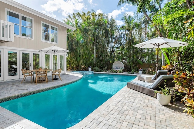 view of pool with a patio and french doors