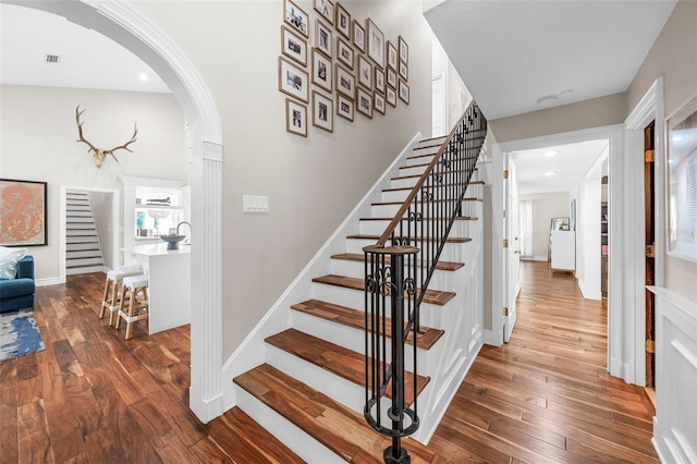 staircase with hardwood / wood-style flooring