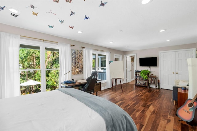 bedroom with dark hardwood / wood-style flooring