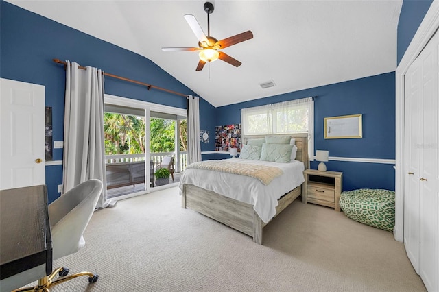 carpeted bedroom featuring ceiling fan, vaulted ceiling, access to exterior, and multiple windows