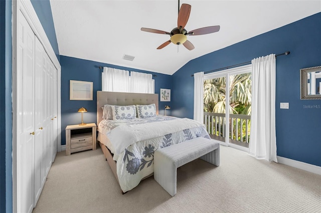 bedroom with access to outside, vaulted ceiling, ceiling fan, light colored carpet, and a closet