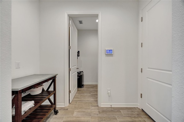 corridor with light hardwood / wood-style flooring