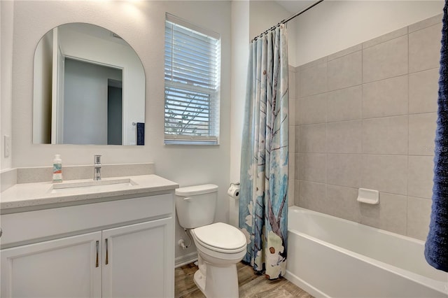 full bathroom featuring hardwood / wood-style floors, shower / bath combo, toilet, and vanity