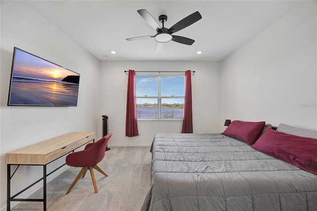 bedroom featuring light colored carpet and ceiling fan