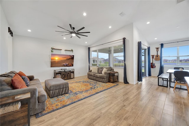 living room featuring lofted ceiling, ceiling fan, and light wood-type flooring