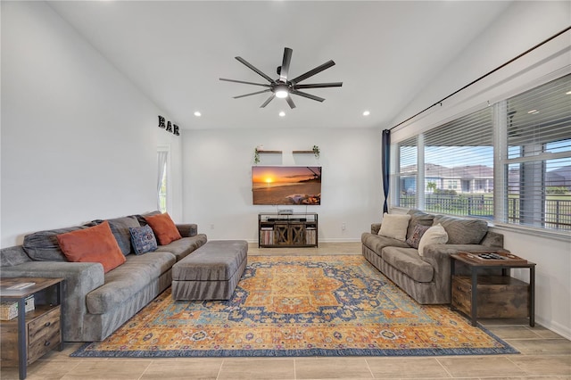 tiled living room with ceiling fan and vaulted ceiling