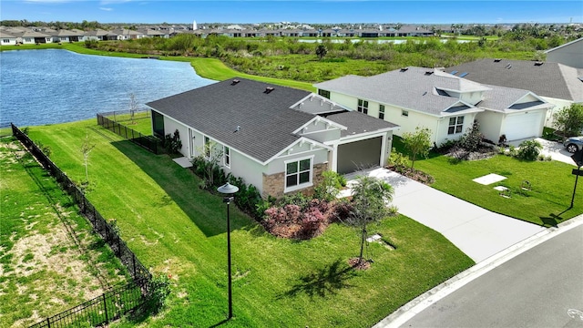 birds eye view of property with a water view